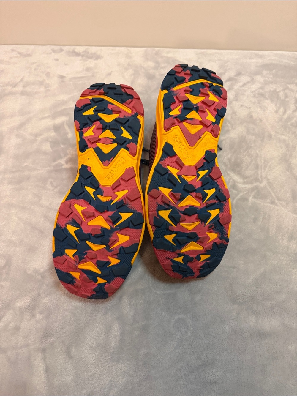Hoka navy blue running shoes with pink and yellow sole - Picture 3 of 4